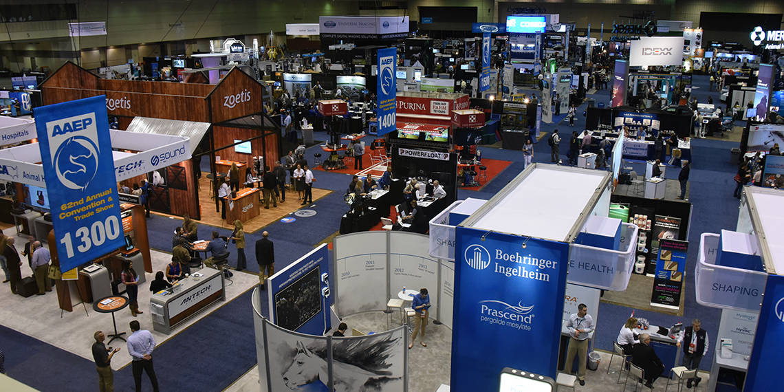 Cleveland Yard Signs in an exhibition hall with various booths and attendees at a trade show.