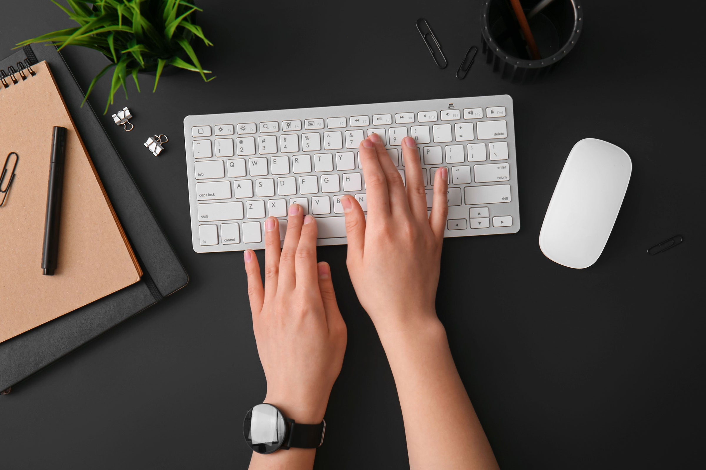 Hands of a designer using a template to create a sign