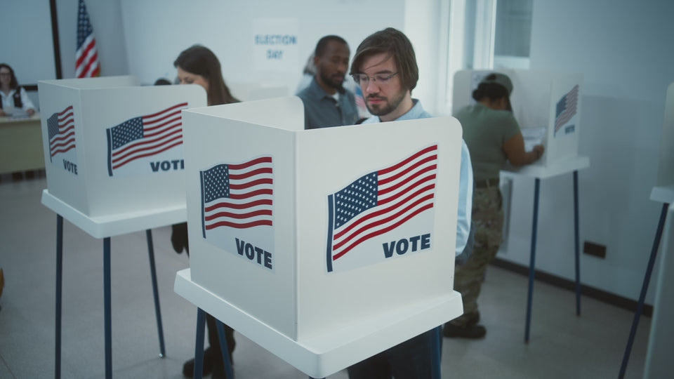 Voters completing ballots at voting booths